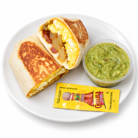 California Breakfast Burrito with guacamole and Cholula on a white plate