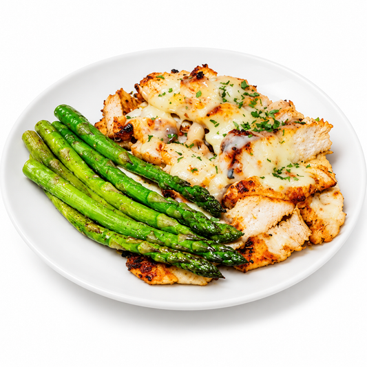 KETO SPICY HABANERO JACK CHICKEN AND ASPARAGUS on a white plate